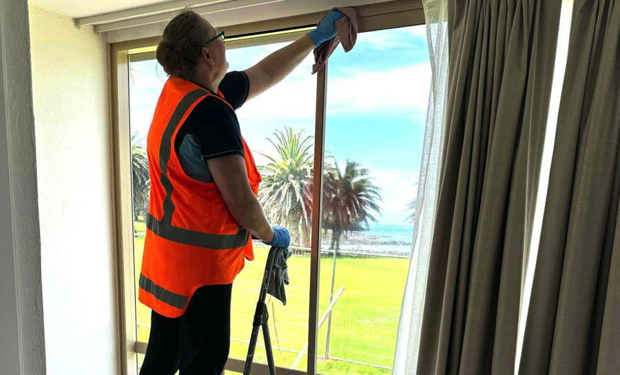 man cleaning window